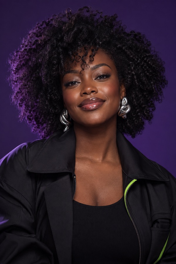 Fashion portrait of a woman with voluminous natural curls and silver earrings